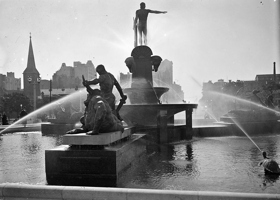 Archibald Fountain silhouetted against the city skyline, Hyde Park, Sydney — photograph, from Archibald Fountain, circa 1934