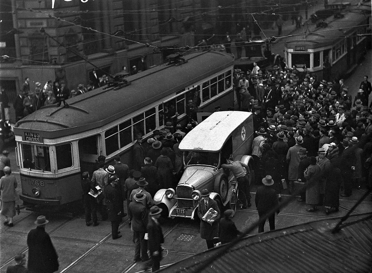 Kings Cross tram accident scene with ambulance and crowd, Sydney — photograph, from Victoria Street, circa 1930