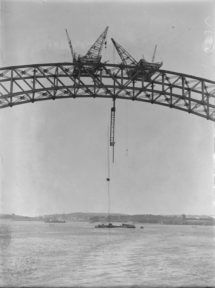 Sydney Harbour Bridge arch under construction, circa 1930 — photograph, from Glen Street, circa 1930