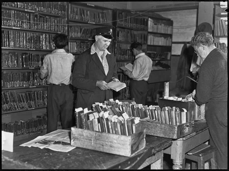 Book sorting inside the library at Parramatta Gaol, 1950 — photograph, from Parramatta Gaol, circa 1950