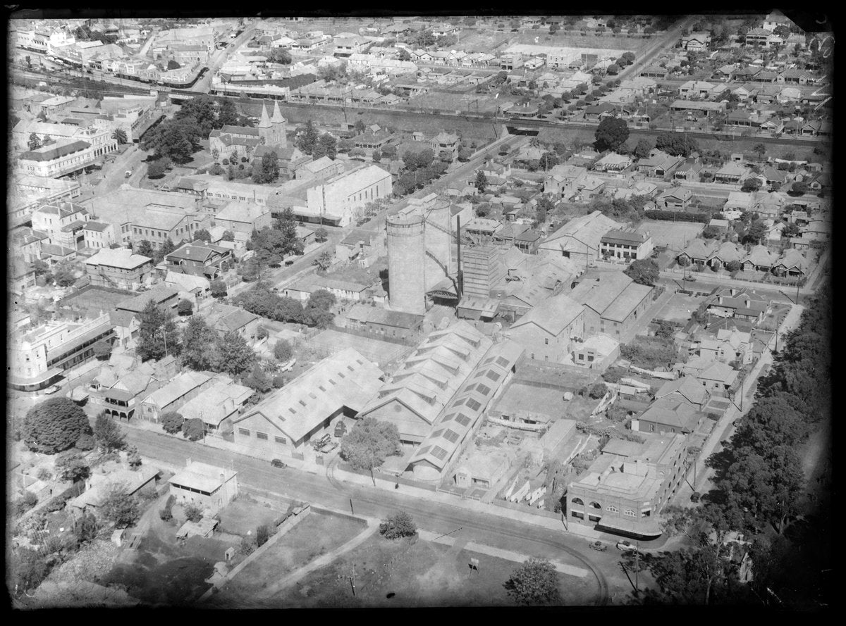 Factory complex, church and channelled waterway from the air — photograph, circa 1939