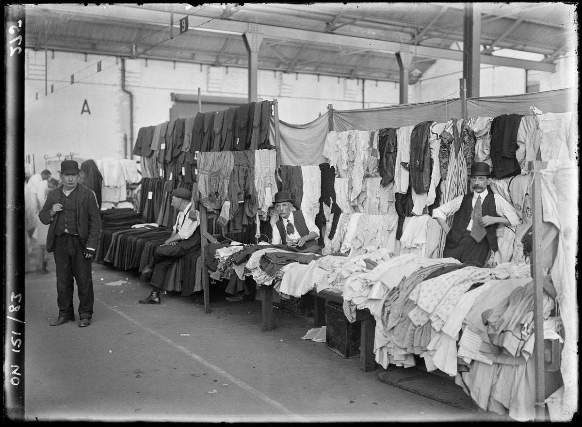 Second-hand clothing stalls at the City Markets, Haymarket — photograph, from City Markets, Hay Street, Haymarket, Sydney, circa 1913