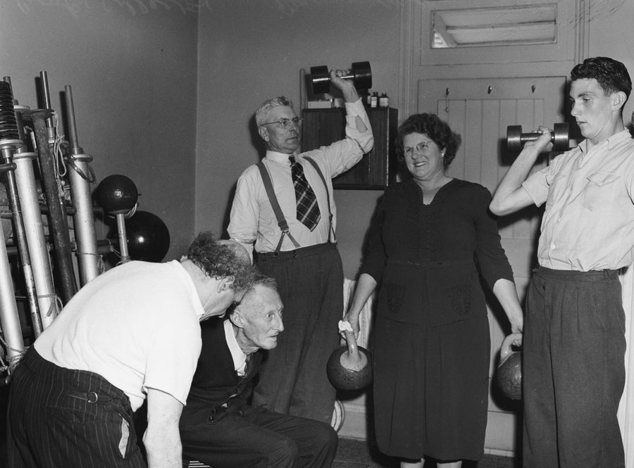 Weight training in a Marrickville room, 1949 — photograph, from Marrickville, circa 1949