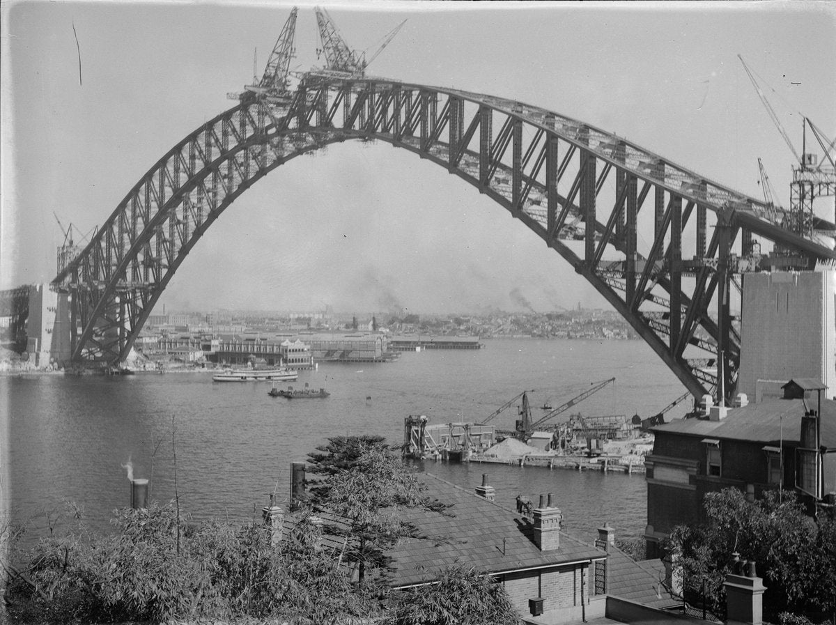 Sydney Harbour Bridge arch nearing completion, 1930 — photograph, from Fitzroy Street, circa 1930