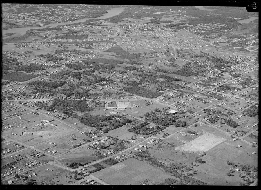 Aerial view over Punchbowl, showing scattered housing and a tidal river beyond — photograph, from Punchbowl, New South Wales, circa 1950