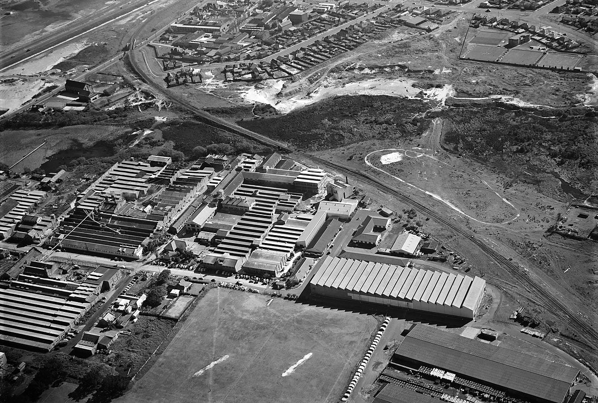 Sawtooth-roofed workshops and railway sidings, Sydney, aerial view — photograph, c. 1950