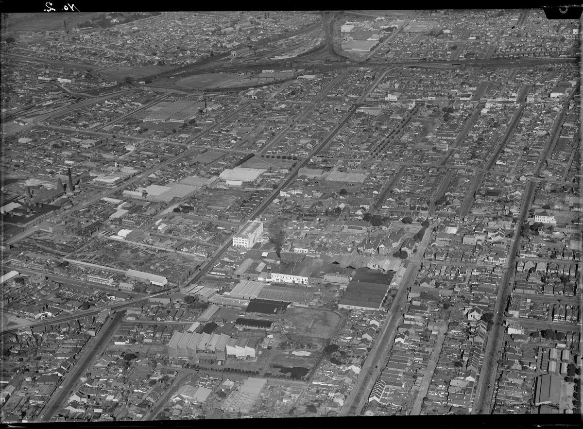 Marrickville from the air: terrace grid, factories and rail lines, after 1935 — photograph, from Marrickville, New South Wales, circa 1935