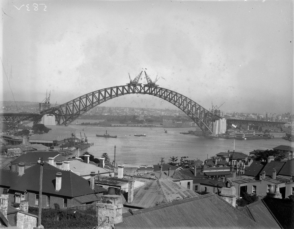 Sydney Harbour Bridge arch nearing completion, 1930 — photograph, from Fitzroy Street, circa 1930