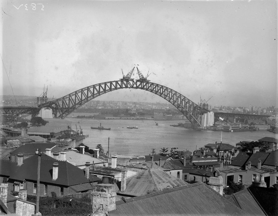 Sydney Harbour Bridge arch nearing completion, 1930 — photograph, from Fitzroy Street, circa 1930