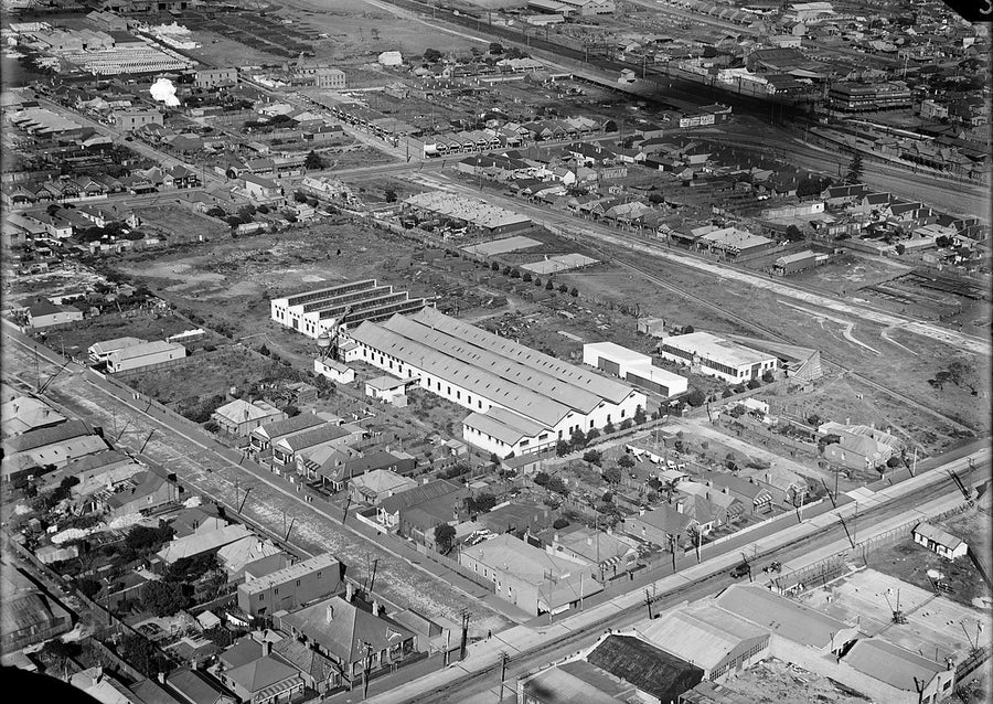 Sawtooth-roofed factory workshops among suburban streets, Rhodes — photograph, from Rhodes, 1930s
