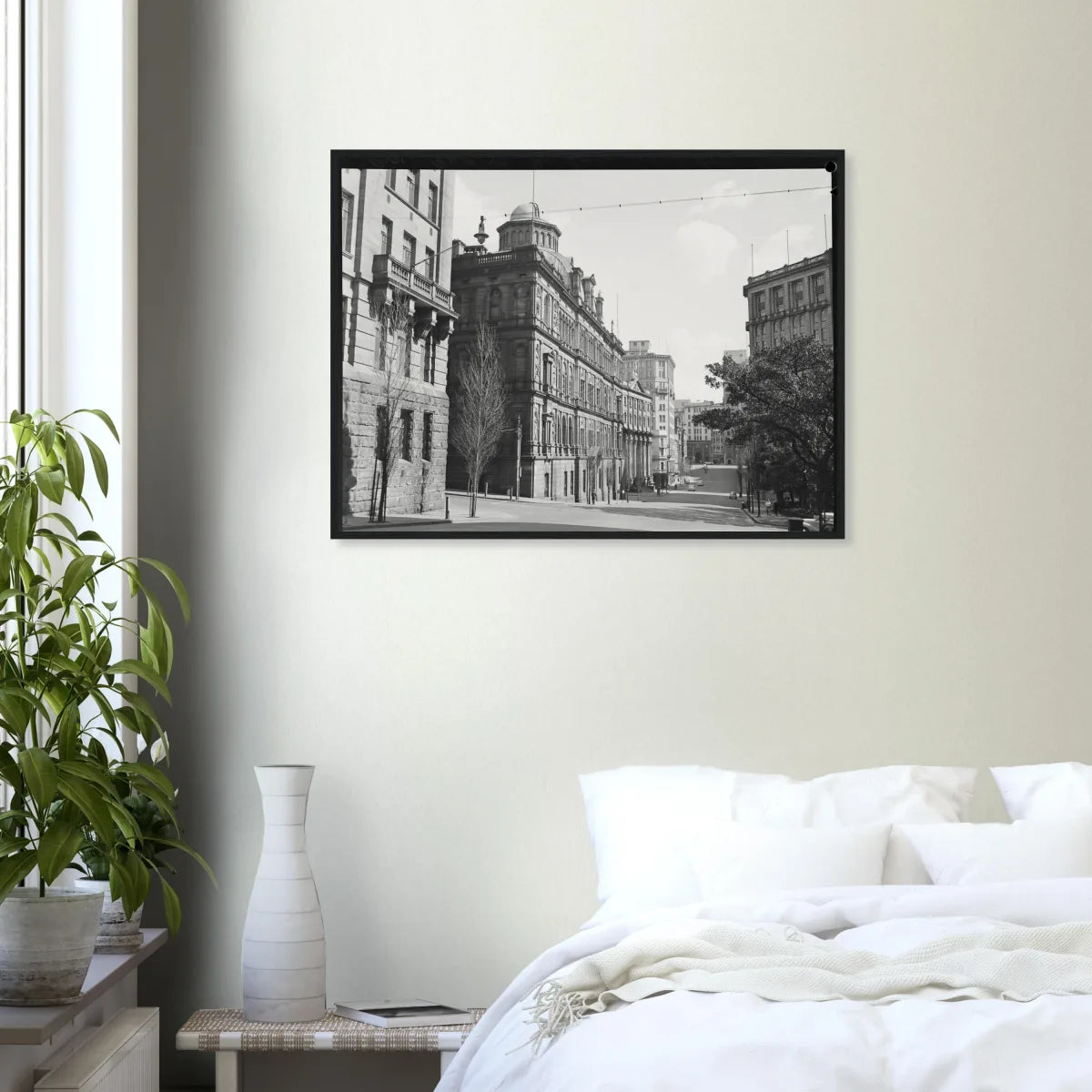 Black-framed print on a bedroom wall